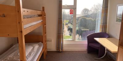 Bedroom with set of bunk beds and large window