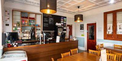 YHA Windermere bar and cafe area with tables and chairs