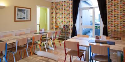 Dining room with tables and brightly coloured chairs