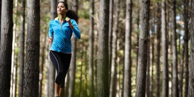 Woman running through trees