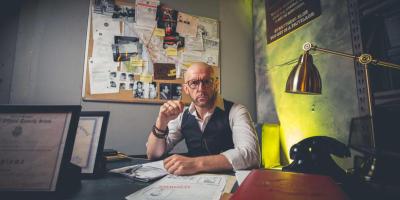 Man sitting at a desk wearing glasses