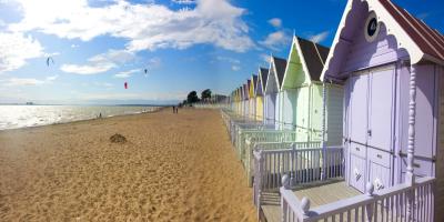 Mersea beach huts and cloudscape in summer