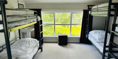 Bedroom with two bunk beds and a large window