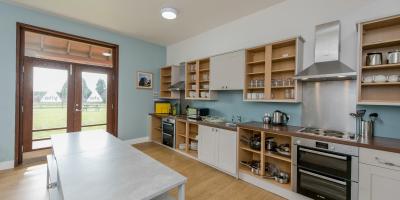 YHA National Forest kitchen with dining table and doors to the outdoor space