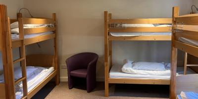 Dormitory style bedroom with three sets of bunk beds