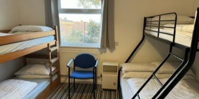 Bedroom with a double bed and single bunks