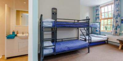 Bedroom with two sets of bunk beds and a door open into an en-suite bathroom