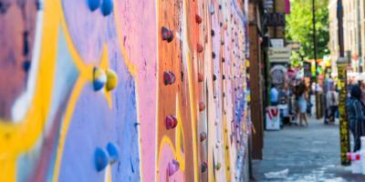 Metal wall covered in colourful grafitti