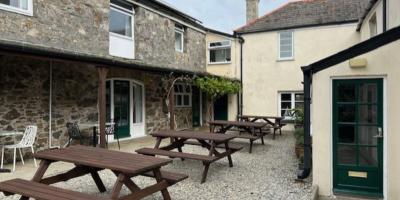 Courtyard outside a stone building with picnic benches