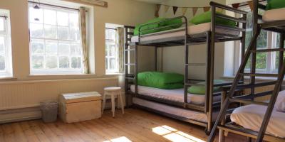 Bedroom with wooden floors and bunk beds at YHA Boggle Hole