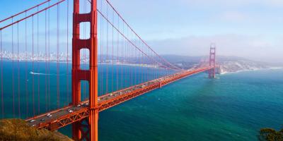 Tall metal bridge over a vast river