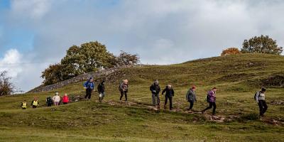 Group of people walking in countryside near YHA Hartington Hall