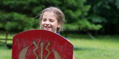 Young female student holding a battle shield at YHA Castleton