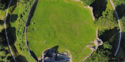 Aerial view of a castle surrounded by a large circular boundary wall