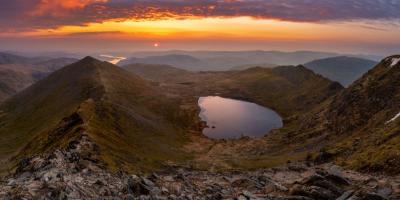 View of the Lake District countryside with a large lake and rolling hills