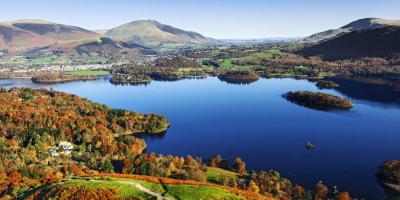 Green rolling hills surrounding a large blue lake