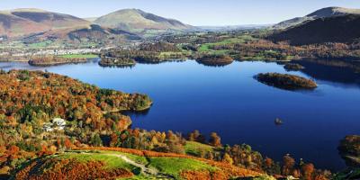 Green rolling hills surrounding a large blue lake