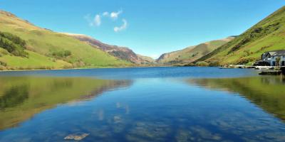 Large open lake surrounded by green hills