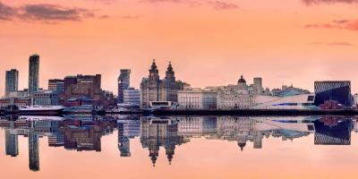 City skyline at sunset with orange skies