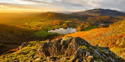 Rolling hills surrounding a lake at sunrise