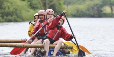 Group of female students steering a raft at YHA Edale