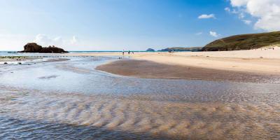 Open sandy beach with the tide lapping at the shore