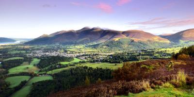 Pink skies over a countryside town surrounded by mountains and trees