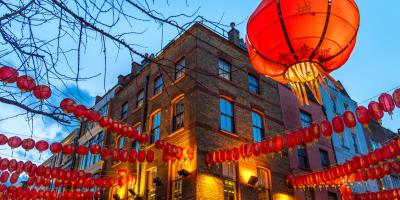 Rows of red Chinese lanterns tied to a building