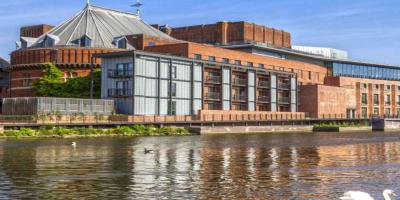 Large theatre building by a river