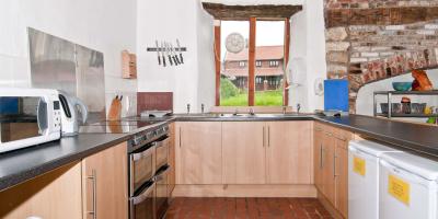 Kitchen with cabinets, oven and microwave