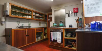 Kitchen with cabinets, oven and kettles