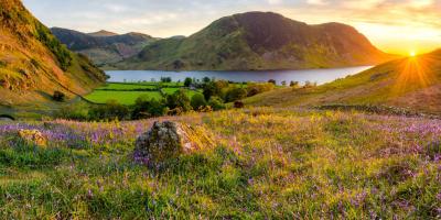 Sunset over rolling hills and a large lake