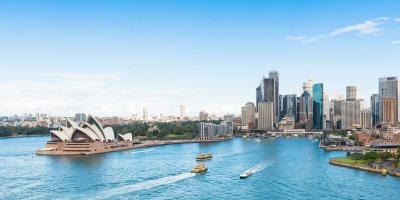 Wide open harbour surrounded by skyscrapers with boats on the water