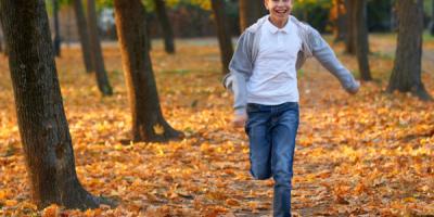 Teenage boy running in forest