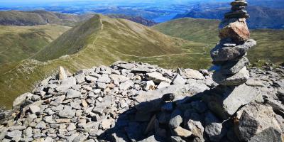 Stack Of Rocks On Helvellyn Summit With Landscape Against Sky