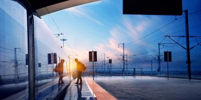 Person boarding a train at sunset