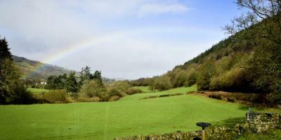 Rainbow in a blue sky over the countryside