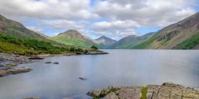 Large open lake surrounded by mountains and countryside