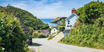 Road leading to the beach with cottages either side