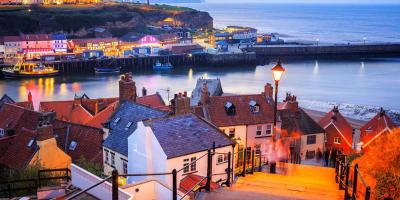 View down some steep steps over a pretty harbour surrounded by houses