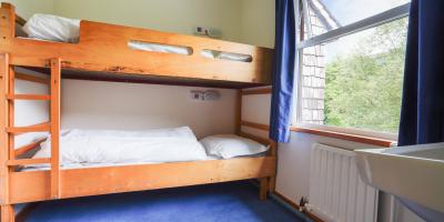 Bedroom with wooden bunk beds and window