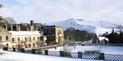 Stone hostel building of YHA Ilam Hall in the snow