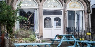 Outdoor seating area with benches and view of the bakery