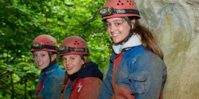 Children with caving outfits on