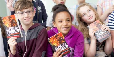 Children holding Alex Rider books