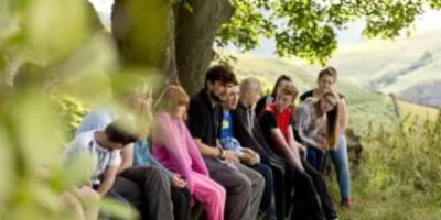 Group of young people sat outdoors