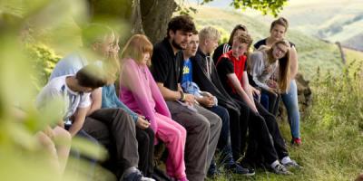 Group of young people and leaders in the countryside 