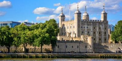 View of the Tower of London, a castle and a former prison in London, England, from the River Thames