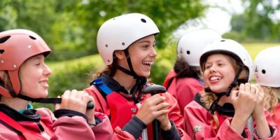 Group of secondary school children wearing safety hard hats