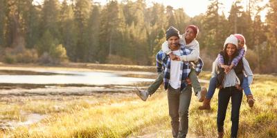 Family walking next to a lake